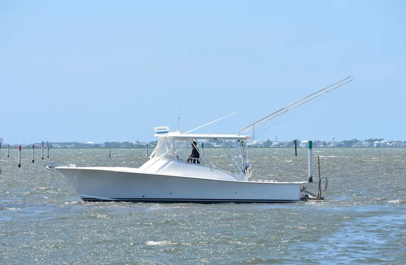 The Image of 2004 Judge 34 Express boat cruising on a sunny day in open waters. - 0