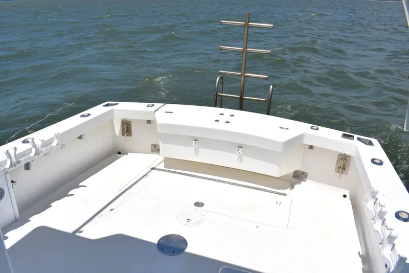 Slide: The Image of 2004 Judge 34 Express boat deck with ocean view, featuring fishing rod holders. - 10