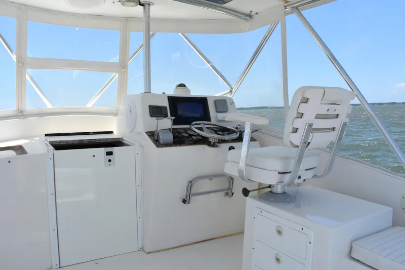 Slide: The Image of Helm of 2004 Judge 34 Express boat with steering wheel and navigation equipment. - 14