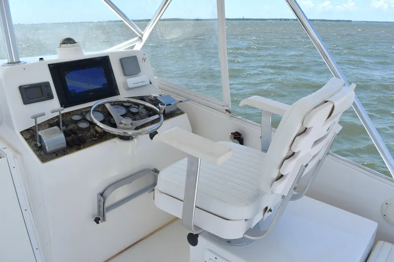 Slide: The Image of 2004 Judge 34 Express boat helm with steering wheel and navigation equipment. - 15