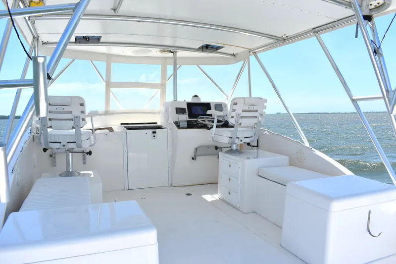 Slide: The Image of 2004 Judge 34 Express boat interior with helm, seating, and ocean view. - 20