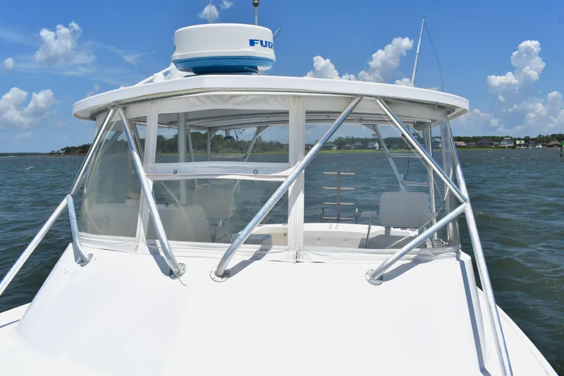 Slide: The Image of 2004 Judge 34 Express boat on water, clear skies, coastal background. - 22