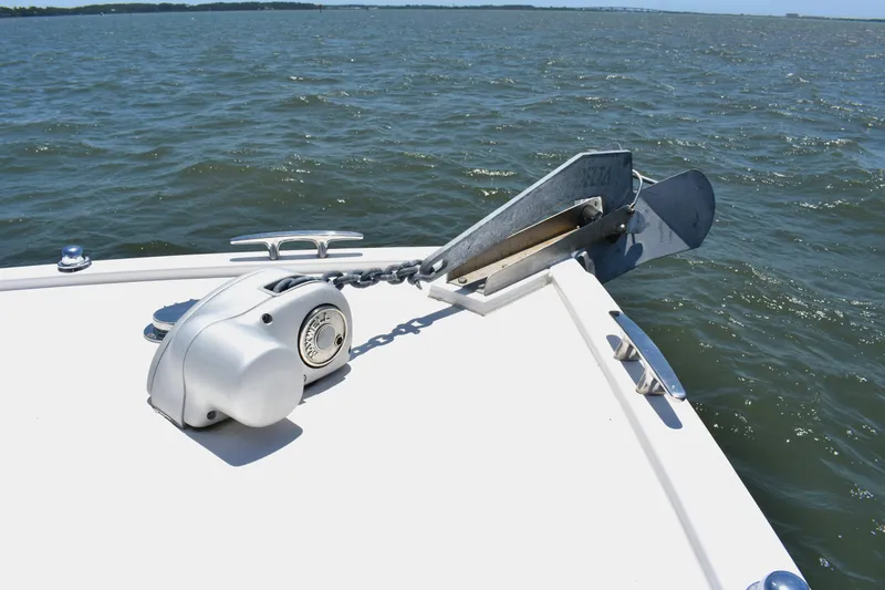 Slide: The Image of Bow of 2004 Judge 34 Express boat with anchor and winch on open water. - 23