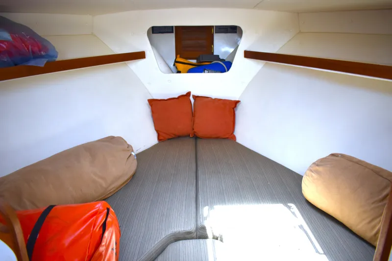 Slide: The Image of 2004 Judge 34 Express boat cabin interior with cushions and storage space. - 28