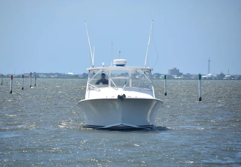 Slide: The Image of 2004 Judge 34 Express boat navigating through calm waters. - 3