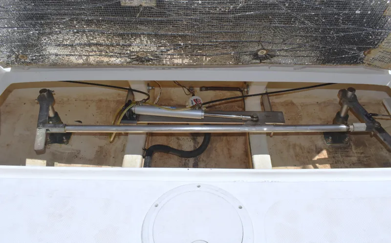 Slide: The Image of Engine compartment of a 2004 Judge 34 Express boat, showing mechanical components. - 30