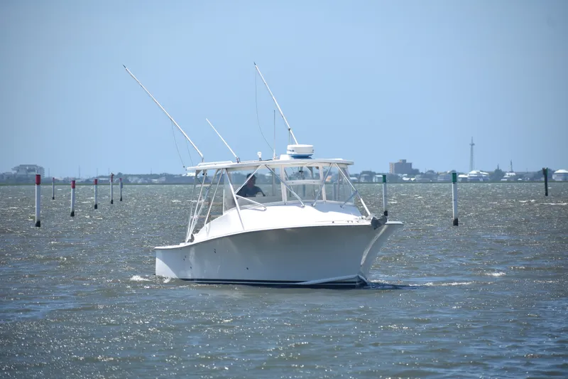 Slide: The Image of 2004 Judge 34 Express boat cruising on a sunny day in open waters. - 4