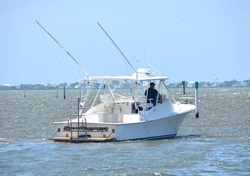Slide: The Image of 2004 Judge 34 Express boat navigating coastal waters under clear skies. - 7