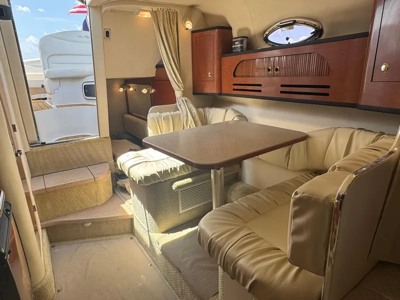 Slide: The Image of Interior of 2004 Sea Ray 280 Sundancer with cozy seating and dining area. - 23