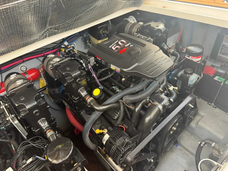 Slide: The Image of Engine compartment of a 2004 Sea Ray 280 Sundancer boat, featuring a MerCruiser 5.0 MPI engine. - 30