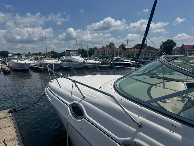 Slide: The Image of 2004 Sea Ray 280 Sundancer docked at a marina under a partly cloudy sky. - 4