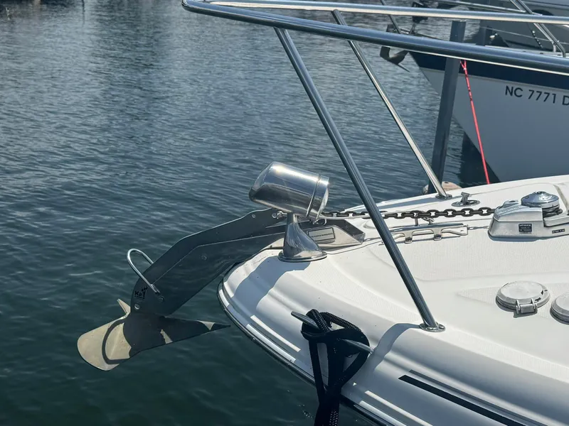 Slide: The Image of 2004 Sea Ray 280 Sundancer boat anchor and deck details on calm water. - 6