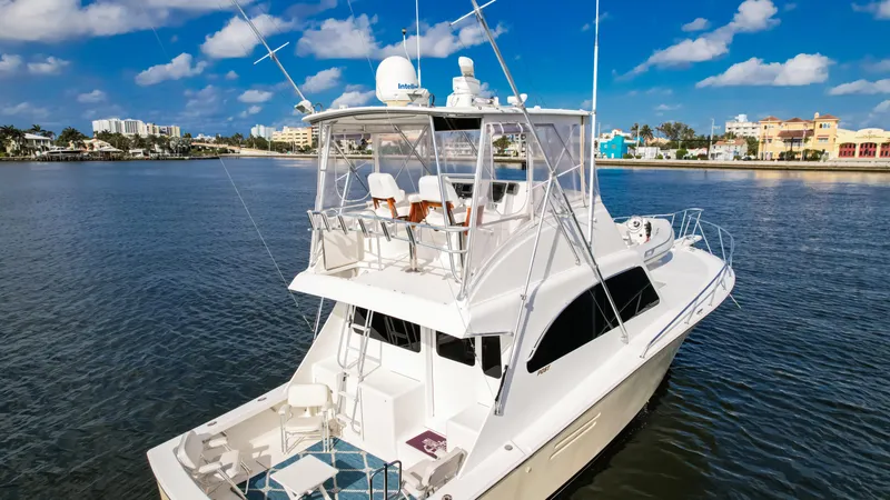 Slide: The Image of Luxury Post 42 yacht from 2008 on calm water under a clear blue sky. - 12