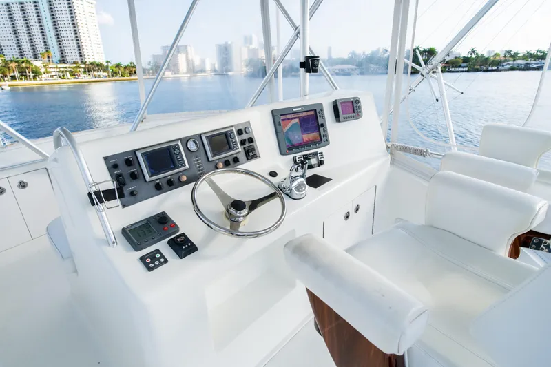 Slide: The Image of Helm of 2008 Post 42 yacht with modern navigation equipment, overlooking waterfront cityscape. - 26