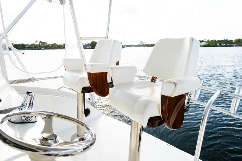Slide: The Image of Luxury yacht helm with white captain chairs, Post 42 model, 2008, overlooking serene water. - 27