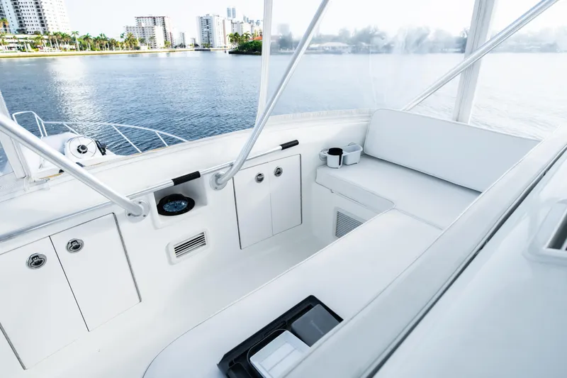 Slide: The Image of Luxurious white yacht interior with seating, overlooking a scenic waterfront cityscape. - 28
