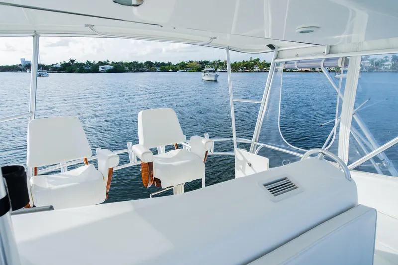 Slide: The Image of Luxury yacht interior with white seating, overlooking calm waters and distant shoreline. - 31