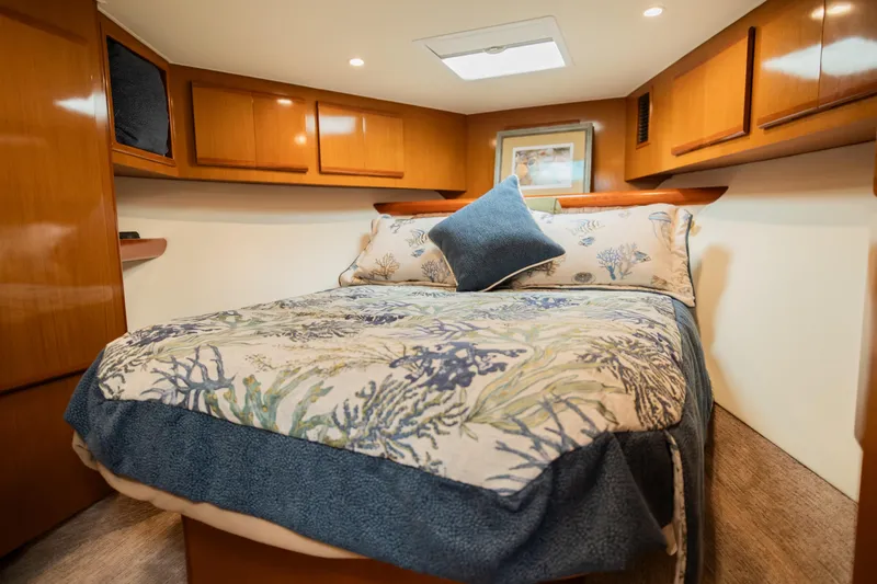 Slide: The Image of Luxurious cabin interior of 2008 Post 42 yacht with cozy bedding and wooden accents. - 43