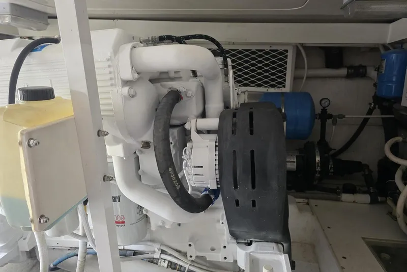 Slide: The Image of Engine room of a 2008 Post 42 model, featuring mechanical components and hoses. - 51