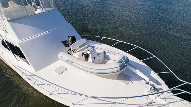 Slide: The Image of Luxury yacht Post 42 (2008) with inflatable boat on deck, cruising on calm waters. - 6