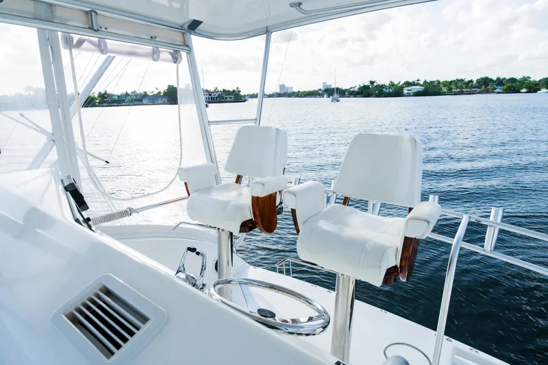 Slide: The Image of Luxury yacht helm with white seats, overlooking serene water. Post 42, 2008 model. - 30