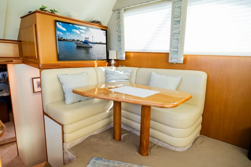 Slide: The Image of Luxurious yacht interior with cozy dining area, featuring plush seating and a mounted TV. - 32