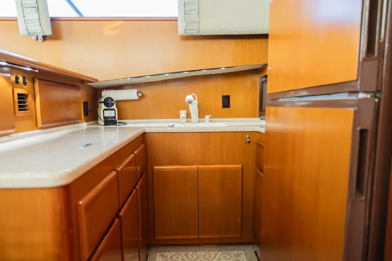 Slide: The Image of Wooden yacht kitchen with modern appliances, featuring a coffee maker and ample storage. Post 42, 2008. - 37