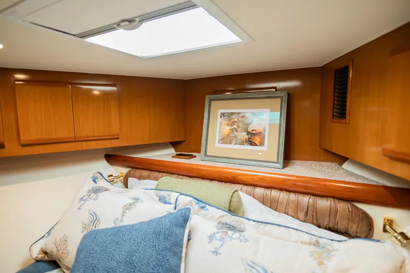 Slide: The Image of Cozy boat cabin with wooden cabinets, decorative pillows, and framed artwork. - 45