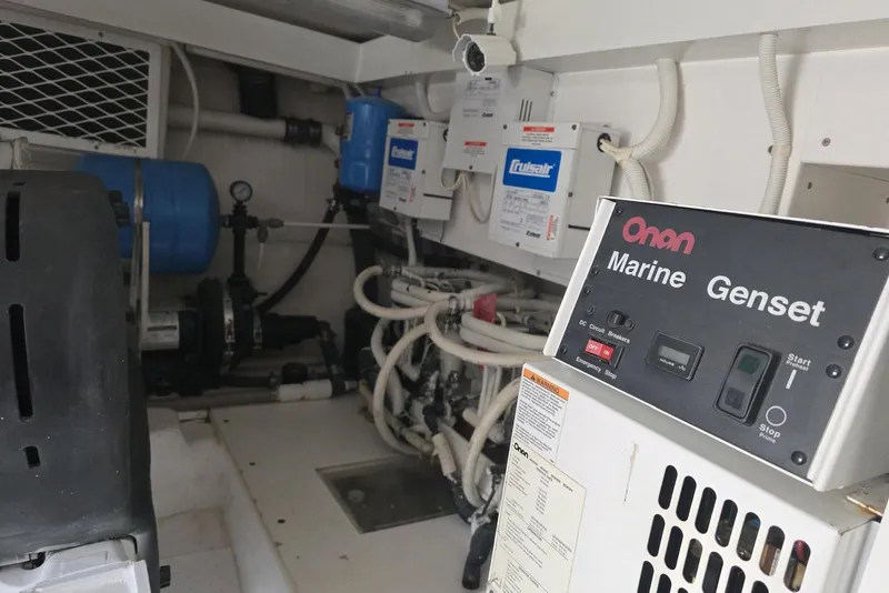 Slide: The Image of Onan Marine Genset in a 2008 Post 42 engine room, featuring various mechanical components. - 46