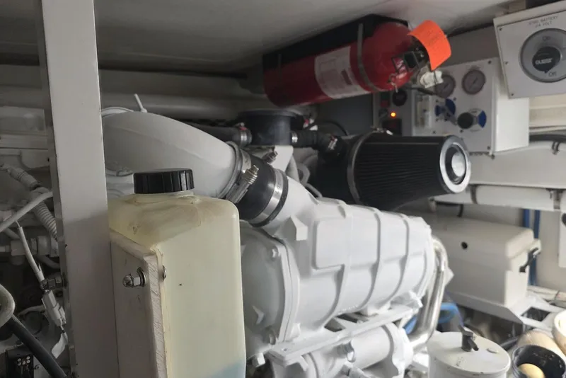 Slide: The Image of Engine room of a 2008 Post 42 boat, featuring machinery and a fire extinguisher. - 47