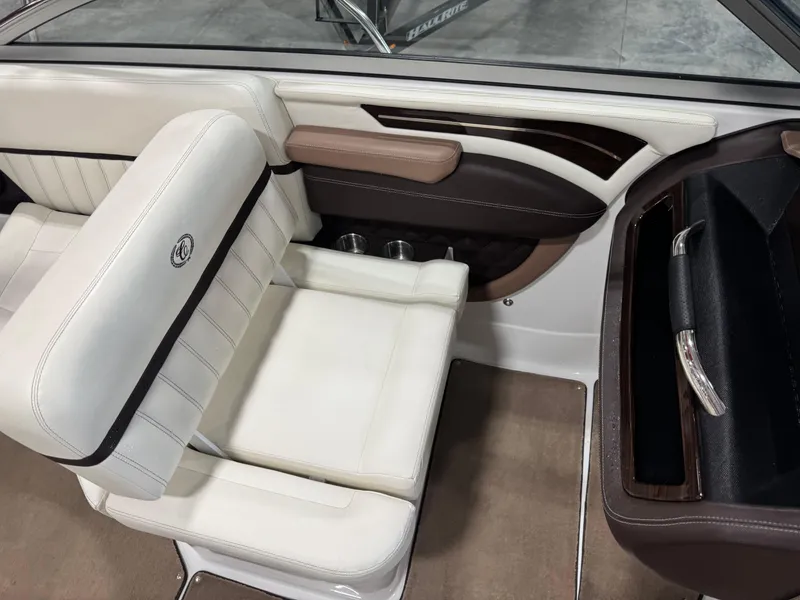 Slide: The Image of Interior of a 2012 Cobalt A-25 boat with white and brown seating. - 11
