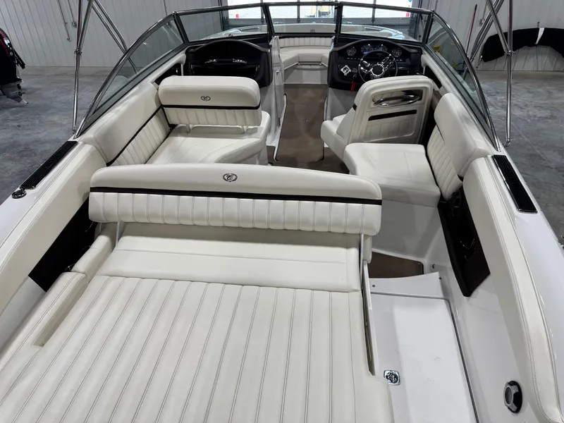 Slide: The Image of Interior of a 2012 Cobalt A-25 boat with white leather seating and sleek design. - 7