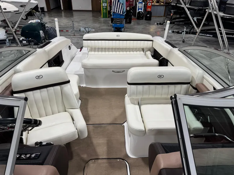 Slide: The Image of 2012 Cobalt A-25 boat interior with white leather seating and beige carpet. - 8