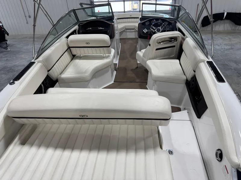 Slide: The Image of 2012 Cobalt A-25 boat interior with white leather seating and steering console. - 9