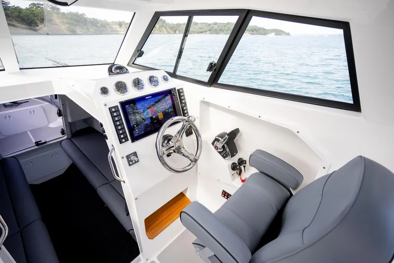 Slide: The Image of Interior of 2020 Protector 310 Targa boat with modern dashboard and steering. - 13
