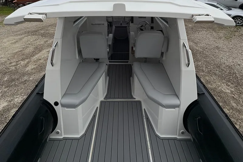 Slide: The Image of Interior view of a 2020 Protector 310 Targa boat with seating and steering area. - 14
