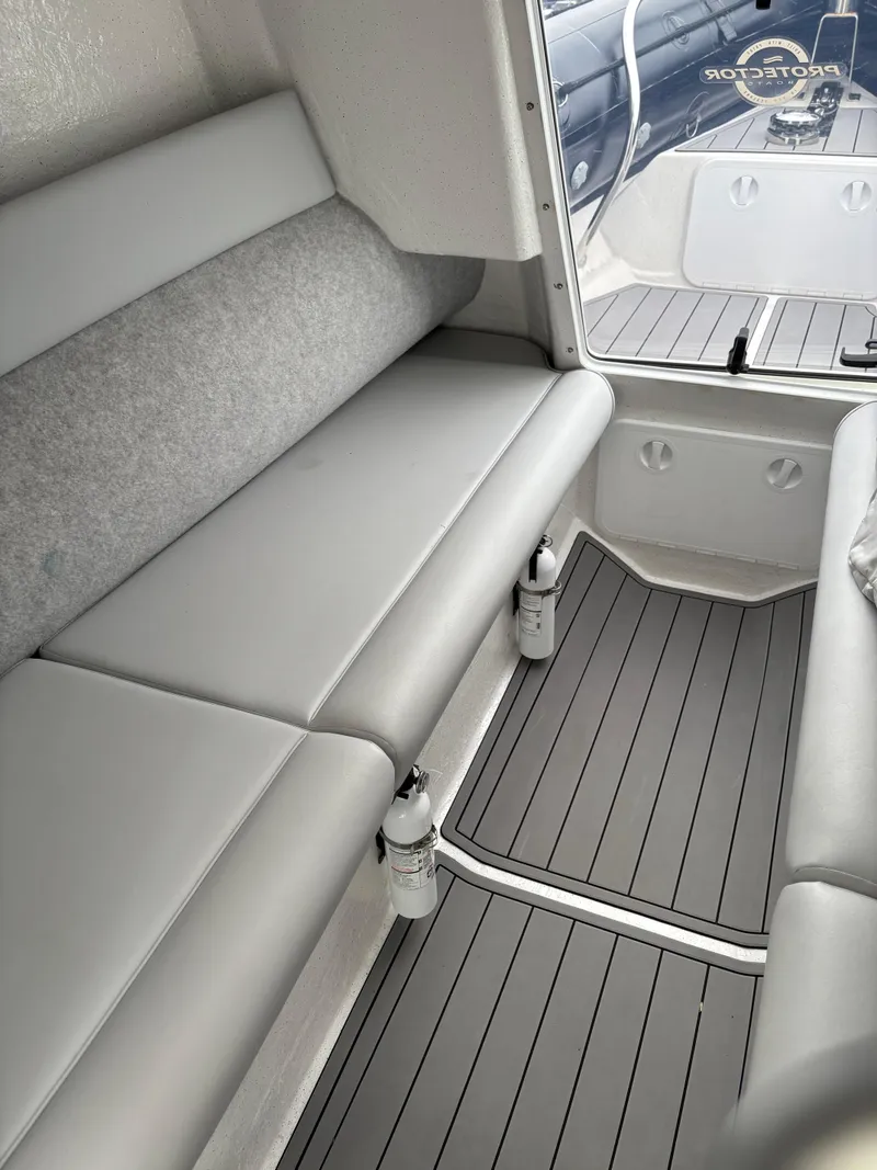 Slide: The Image of Interior of a 2020 Protector 310 Targa boat with gray seating and flooring. - 16