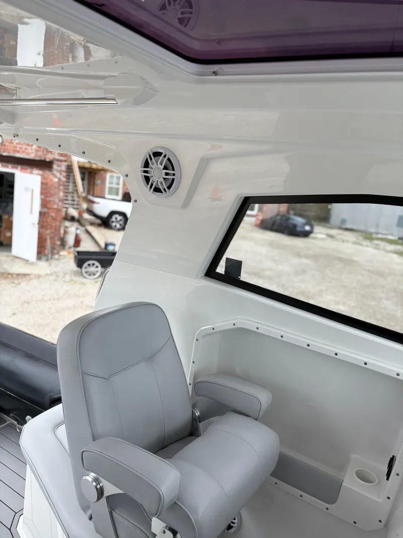 Slide: The Image of Interior of 2020 Protector 310 Targa boat with gray seating and speaker. - 25