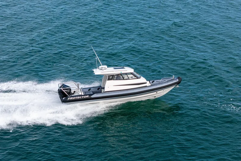 Slide: The Image of 2020 Protector 310 Targa boat cruising on open water. - 26