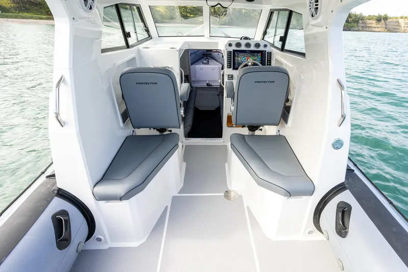 Slide: The Image of Interior of 2020 Protector 310 Targa boat with modern seating and control panel. - 4