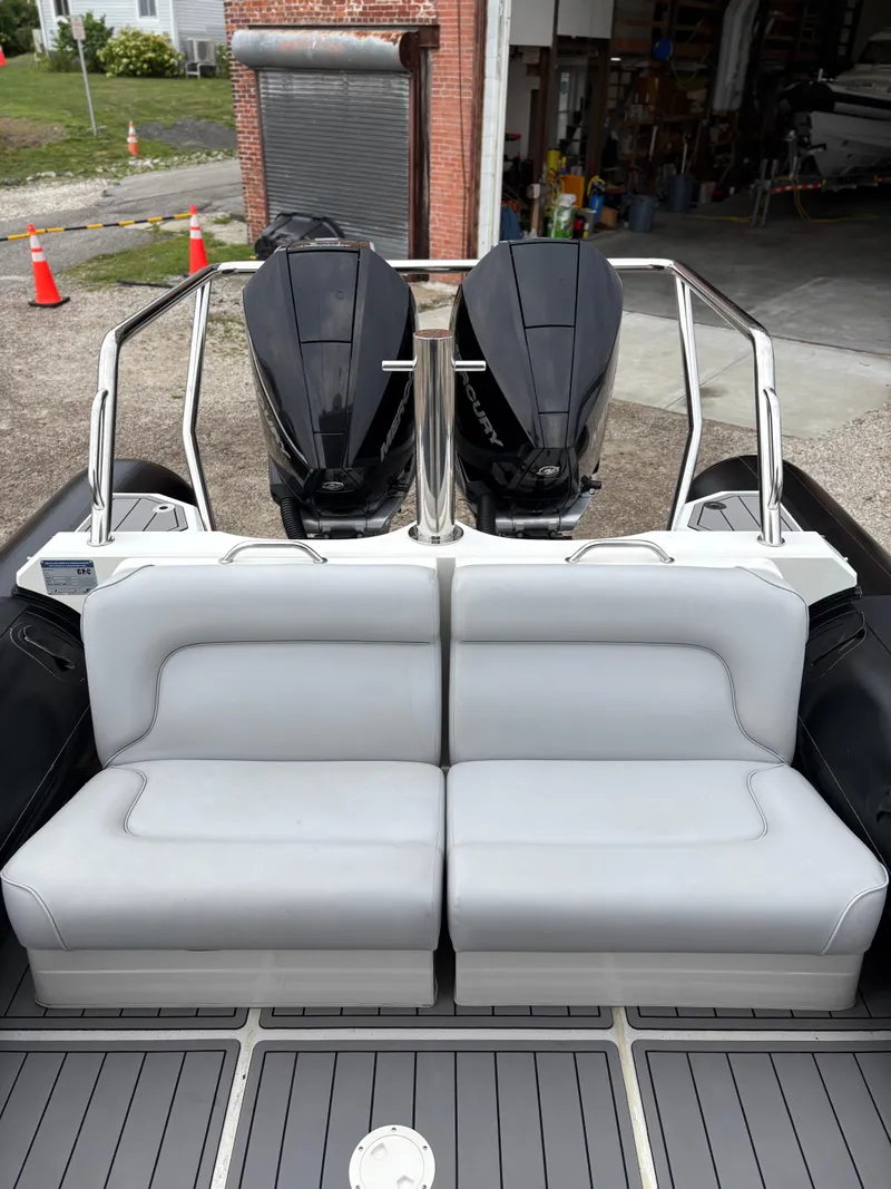 Slide: The Image of 2020 Protector 310 Targa boat with dual engines and cushioned seating. - 9