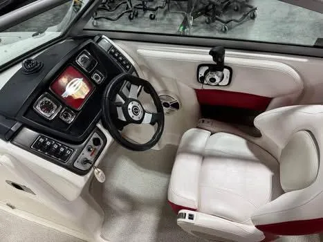 Slide: The Image of 2009 Chaparral 264 Sunesta boat cockpit with steering wheel and control panel. - 11