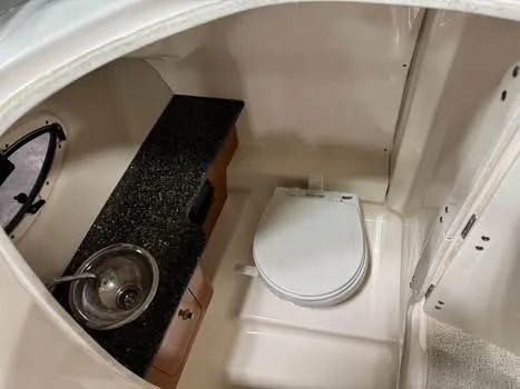 Slide: The Image of 2009 Chaparral 264 Sunesta boat interior with sink and toilet. - 16