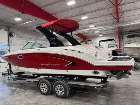 Slide: The Image of 2009 Chaparral 264 Sunesta boat with red and white design in indoor storage. - 3