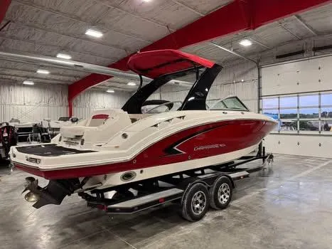 Slide: The Image of 2009 Chaparral 264 Sunesta boat in a showroom, red and white design, on a trailer. - 4