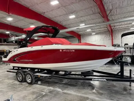 Slide: The Image of 2009 Chaparral 264 Sunesta boat in a showroom, red and white design on a trailer. - 6