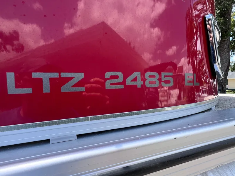 Slide: The Image of 2022 Tahoe Pontoon LTZ 2485 EL, red exterior with reflective details. - 10