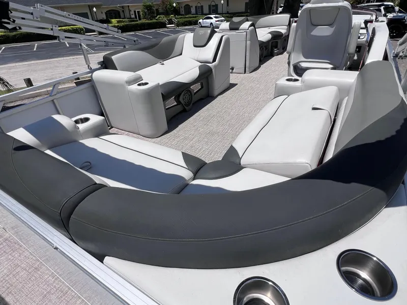 Slide: The Image of 2022 Tahoe Pontoon LTZ 2485 EL interior with luxurious seating and cup holders. - 17