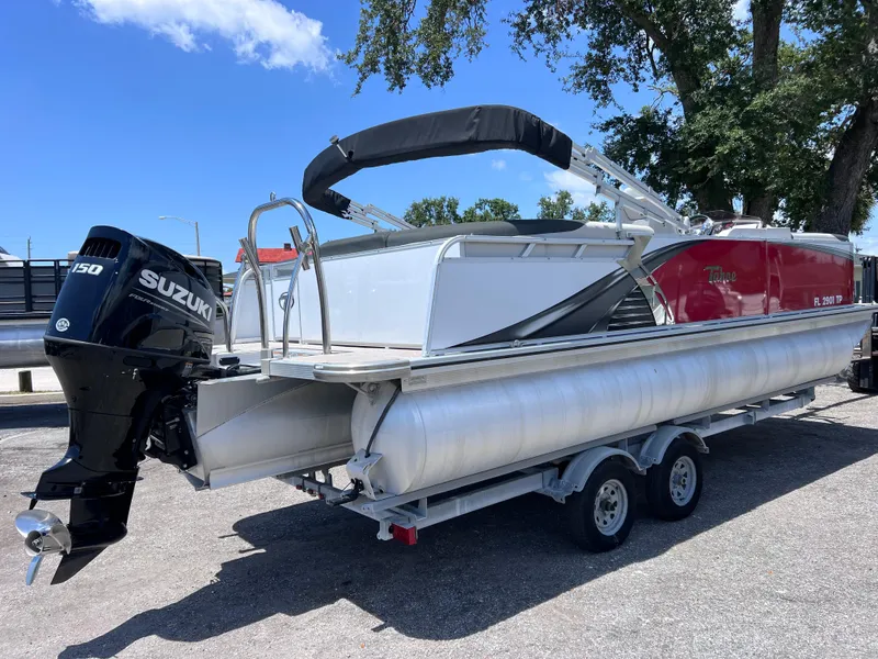 Slide: The Image of 2022 Tahoe Pontoon LTZ 2485 EL with Suzuki outboard motor on trailer. - 2