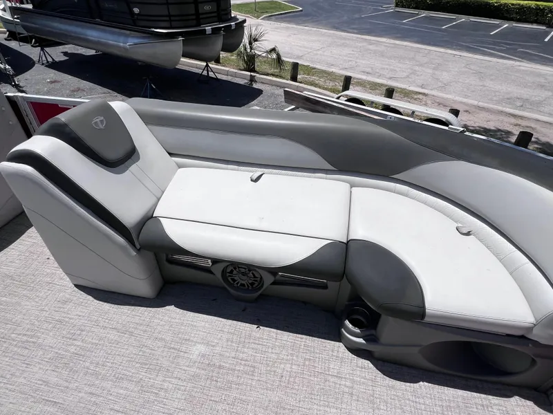Slide: The Image of 2022 Tahoe Pontoon LTZ 2485 EL boat interior with gray seating and speaker. - 23